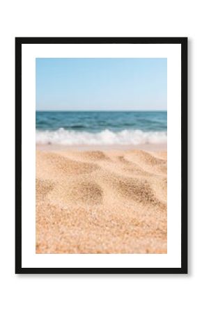 Close Up View of Light Brown Sand Beach with Ocean Waves and Blue Sky
