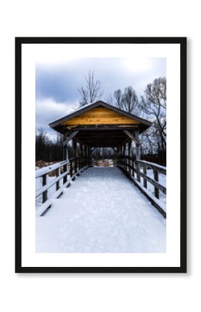 wooden covered bridge in the snow