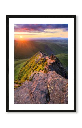 Golden summer sunrise from Blencathra overlooking Sharp Edge in The Lake District, UK.