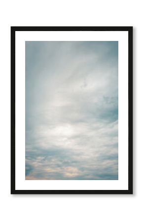 Soft overcast sky with layered clouds in muted blue and gray tones. Peaceful and dreamy natural background perfect for abstract, nature, or weather themes
