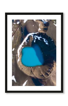 Krafla Crater features a stunning turquoise geothermal lake surrounded by rugged terrain and volcanic rock in Iceland