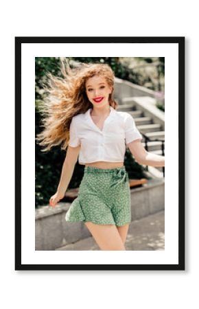 Adorable woman enjoying a sunny outdoor city stroll with vibrant style and cheerful expressions in casual summer attire