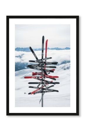 Unique ski signpost on a snowy mountain peak