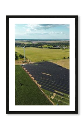 Rural farmland with solar panels and wind turbine
