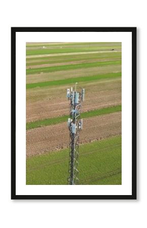 Cell tower overlooking green countryside fields