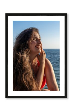 Woman smiling ocean, happy young woman with long flowing hair enjoying sun by the sea, summer vacation