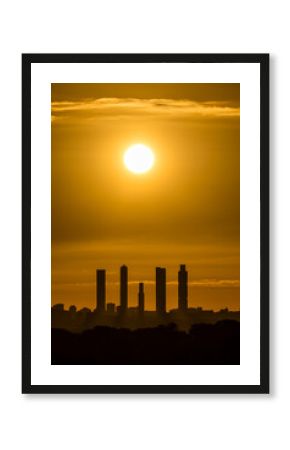Sunrise views of the Madrid skyline through the morning mist