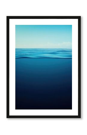 Calm blue sea split view, clear sky above, tranquil underwater gradient below showing serene ocean depth and glassy horizon reflection