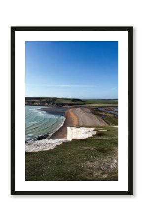 Panoramic view of Seven Sisters Cliffs along the East Sussex coast with blue sky and sandy beach