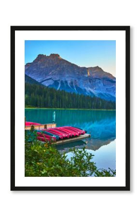 Emerald Lake Dock with Canoes and Mountain Reflections in Tranquil Water