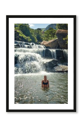 Waterfall, mountain and portrait of woman in river for adventure at travel destination outdoors. Swimmer, journey and person relax in water, dam and nature stream for holiday, vacation and tourism