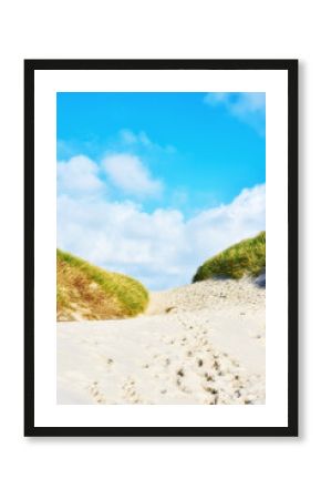 Beach sand, grass and path in nature with sky, natural environment and resident access. Wallpaper, plants and walkway at seaside for travel, summer vacation and dunes on Denmark coastline with growth