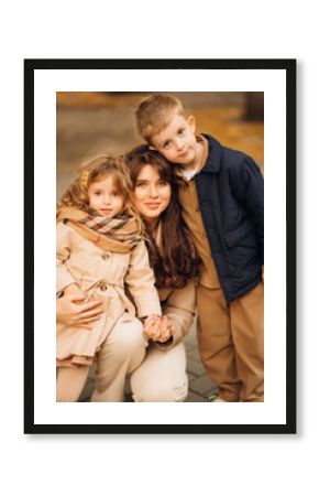 Mother and children enjoying a day out in the park during early autumn