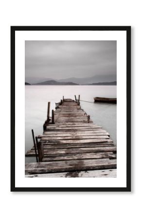 Looking over a pier and a boat, low saturation