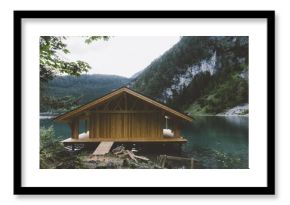 Wood house on lake with mountains and trees