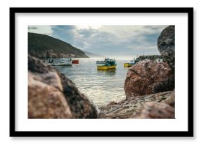 Beautiful view of a seascape with fishing boats in the water from a shore