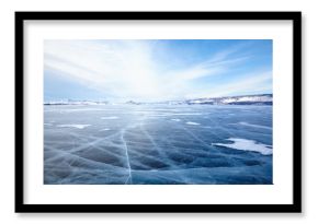 Winter ice landscape on lake Baikal with dramatic weather clouds