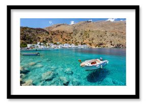 Small motorboat at clear water bay of Loutro town on Crete island, Greece