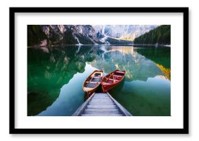 Boats on the Braies Lake ( Pragser Wildsee ) in Dolomites mounta