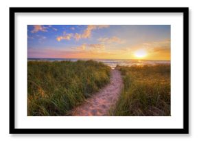 Path To A Summer Sunset Beach. Winding trail through dune grass leads to a sunset beach on the coast of the inland sea of Lake Michigan. Hoffmaster State Park. Muskegon, Michigan.