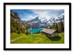 Amazing tourquise Oeschinnensee with waterfalls, wooden chalet and Swiss Alps, Berner Oberland, Switzerland.