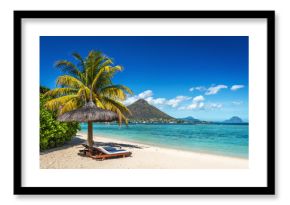 Loungers and umbrella on tropical beach in Mauritius
