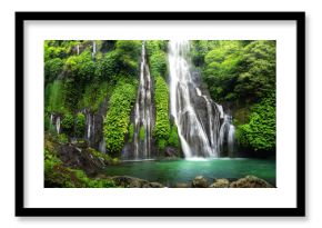 Jungle waterfall cascade in tropical rainforest with rock and turquoise blue pond. Its name Banyumala because its twin waterfall in mountain slope