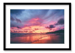 Beautiful sunset on ocean beach. Sky is reflecting at water.