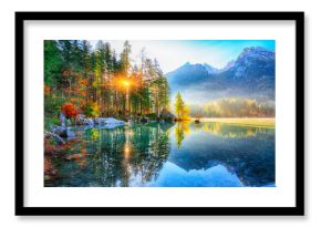 Beautiful autumn sunrise scene with trees near turquoise water of Hintersee lake