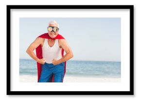 Red superhero-style cape fluttering at sandy beach edge, reflective goggles shining under clear sky