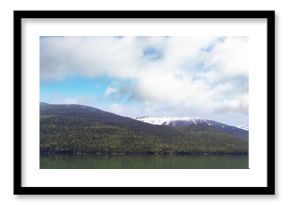 Mountains by river against sky