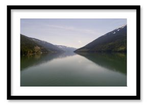 Mountains reflecting on river against sky