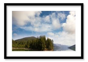 Trees growing by lake and mountains against sky