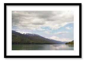 River and snowcapped mountains against cloudy sky