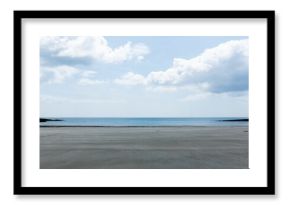Wide wet sand shoreline is stretching in flat design, with calm sea, cloudy sky, rocky outcroppings