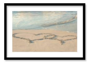 Heart shape drawing on sand at beach