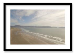 Sea coastline against cloudy sky