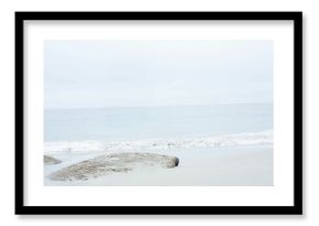 Flat rocky outcrop is appearing in minimalist flat design coastal scene, with tidal pool and waves