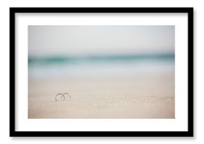 Close-up of wedding rings at beach