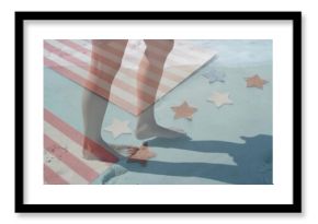 Stepping bare feet on sandy painted surface at beach edge, with striped towel, star-shaped cutouts