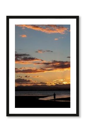 Vertical of a sunset over the beach in Nelson, New Zealand.