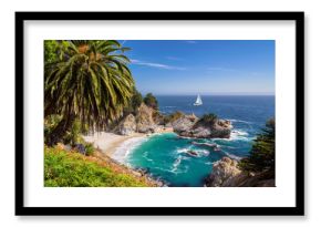 Beautiful beach with palm trees and the white yacht on the horizon.  Julia Pfeiffer beach, Big Sur. California, USA