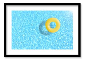 yellow swimming pool ring float in blue water. concept color summer.