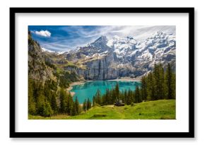 Amazing tourquise Oeschinnensee with waterfalls, wooden chalet and Swiss Alps, Berner Oberland, Switzerland.