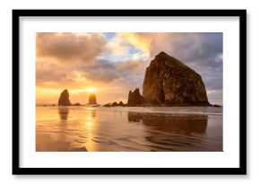 The sun sets behind Haystack Rock off the Oregon Coast