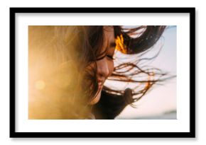 Young women feel winter wind on the beach