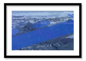 Image of blue graphs and charts moving over birds and waves splashing on rocky beach