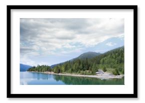 Trees reflecting in calm lake against sky