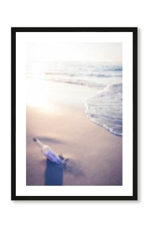 Message in a bottle at sunny sea shore