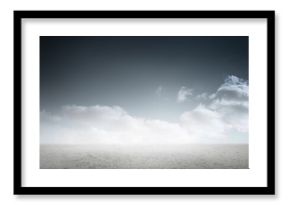 Image of white clouds lit by sunlight over horizon, sea and empty beach